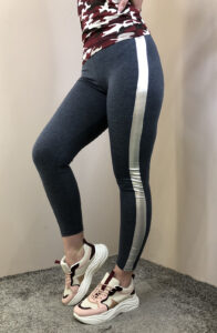 Desk with leather desk pad, walnut desk organizer, wireless keyboard and mouse, and porcelain mug.