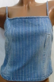 Desk with leather desk pad, walnut desk organizer, wireless keyboard and mouse, and porcelain mug.