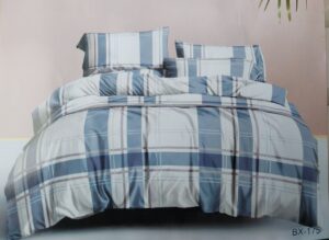 Desk with leather desk pad, walnut desk organizer, wireless keyboard and mouse, and porcelain mug.