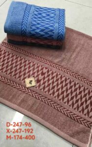 Desk with leather desk pad, walnut desk organizer, wireless keyboard and mouse, and porcelain mug.